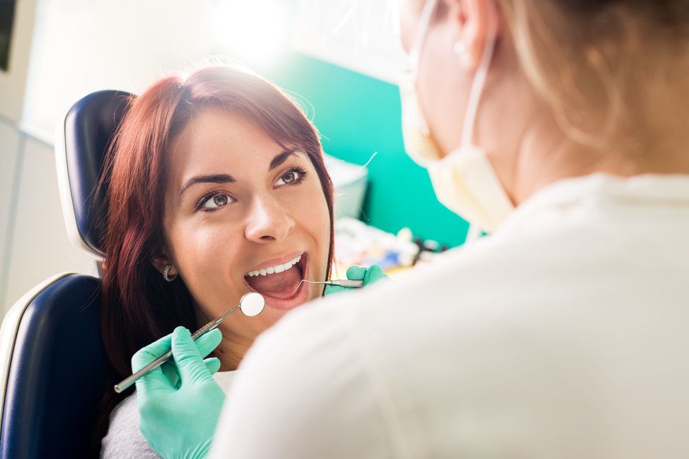 Smiling patient undergoing dental exam