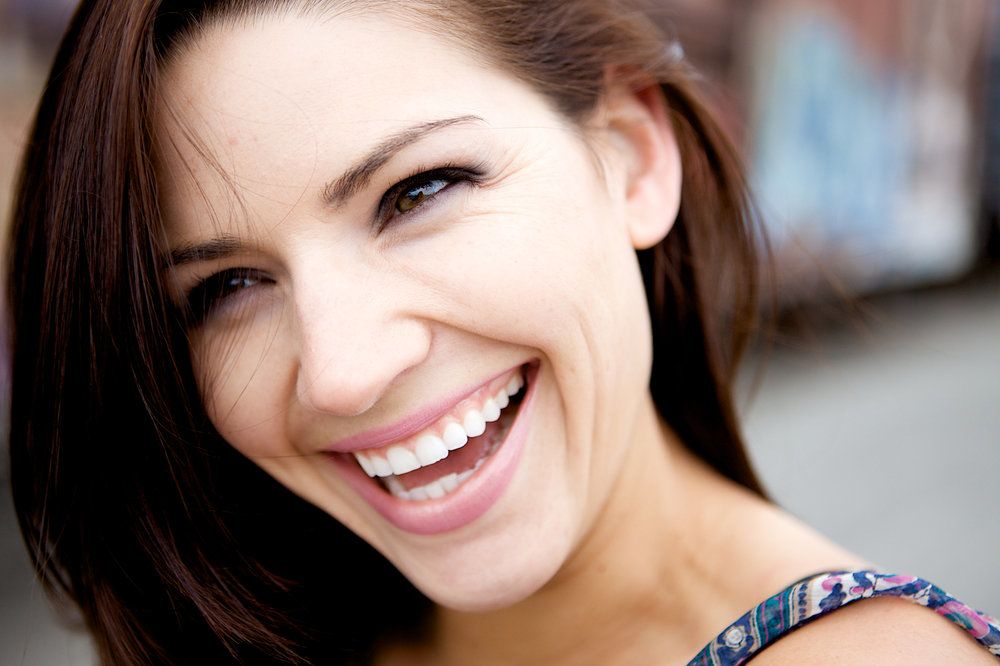 Laughing brunette woman squinting eyes
