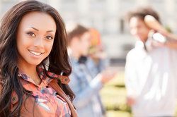 Smiling, attractive woman with long wavy brown hair